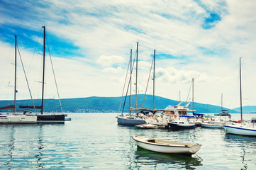 Fototapeta na wymiar Yachts in the sea port of Tivat, Montenegro. Kotor bay, Adriatic sea. Famous travel destination.