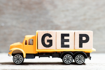 Truck hold letter block in word GEP (abbreviation of good engineering practice) on wood background