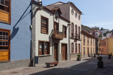 Fototapeta na wymiar Picturesque facades of old houses on the street of the historical La Laguna town, Tenerife, Canary Islands, Spain.