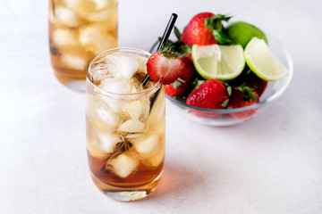 Glasses of Cold Citrus and Strawberry Ice Tea on Light Gray Background Decorated with Ripe Lime and Strawberry Healthy Symmer Beverage Refreshing Drink
