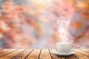 a hot coffee on the table on a spring background