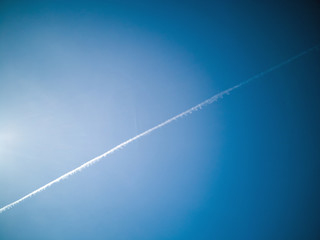 Fototapeta na wymiar Condensing stripes in the blue sky over Germany
