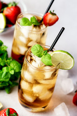 Glasses of Cold Citrus and Strawberry Ice Tea on Light Gray Background Decorated with Ripe Lime and Strawberry Healthy Symmer Beverage Refreshing Drink Above