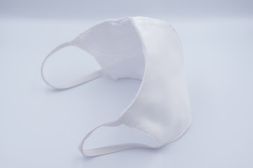 White cloth mask for COVID-19 pandemic protection isolated on white background - Health care concept. 
