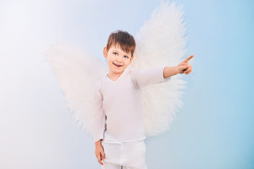 Angel boy in white with wings