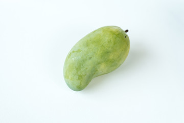 Raw mangoes in a white scene