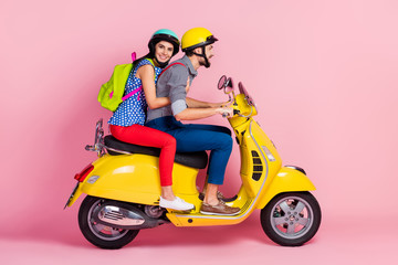 Fototapeta na wymiar Profile side view of his he her she nice attractive cheerful couple driving moped pastime having fun spending vacation holiday adventure isolated over pink pastel color background