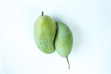 Raw mangoes in a white scene
