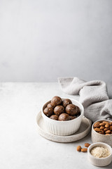 energy balls of oatmeal, nuts and dried fruits on a light gray background. Healthy eating . Place for text.