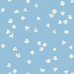 Vector beautiful ditsy floral seamless texture. Repeating pattern of small white flowers on blue background. 50's style design for fabric and wallpaper.