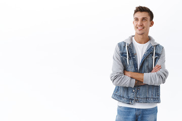 Happy enthusiastic caucasian guy cross arms chest, looking upper left corner with dreamy satisfied...