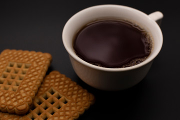 Mug of tea and cookies on a dark background. Чаепитие.
