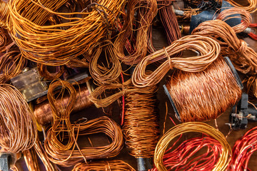 Closeup of copper waste in the form of copper wires, coils and transformers in landfill. - obrazy, fototapety, plakaty