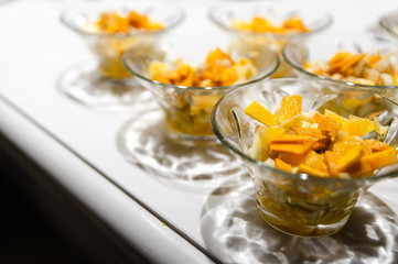 fresh fruit dessert jam poured on a white table,many desserts for the buffet,healthy vegetarian dessert with healthy fruits,fruit dessert for a healthy diet