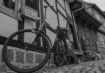 old bicycle in front of old house