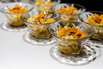 fresh fruit dessert jam poured on a white table,many desserts for the buffet,healthy vegetarian dessert with healthy fruits,fruit dessert for a healthy diet