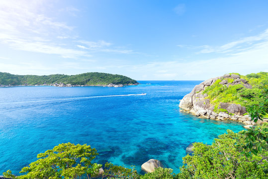 Landscape view from mountain peak to see ocean bay island blue sea water abd sky with speedboat cross the bay