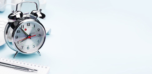 Blue workplace with alarm clock