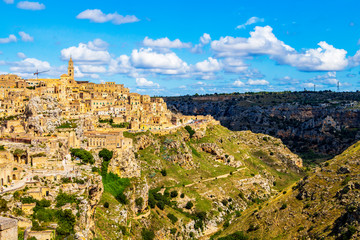 Fototapeta premium Scenic panoramic sunny summer view of Matera and the canyon of Matera in the Province of Matera, Basilicata Region, Italy