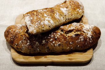 fresh bread on linen,bread lies on a cutting board,baked bread lies on the table,sliced ​​bread on linen background,home baked loaf,home made bread