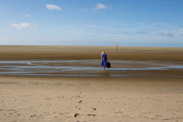 woman walks away on beach