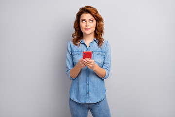 What post. Minded interested curious woman use cellphone think thoughts look copyspace choose blogging subjects wear modern outfit isolated over grey color background