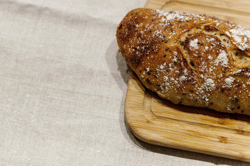 fresh bread on linen,bread lies on a cutting board,baked bread lies on the table,sliced ​​bread on linen background,home baked loaf,home made bread