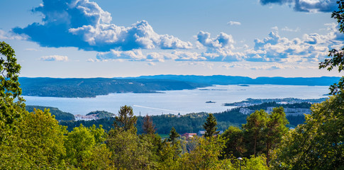 Oslo, Norway - Panoramic view of metropolitan Oslo and Oslofjorden sea bays and harbors seen from the Holmenkollen hill - obrazy, fototapety, plakaty