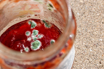 a red jam with mold on the surface - obrazy, fototapety, plakaty