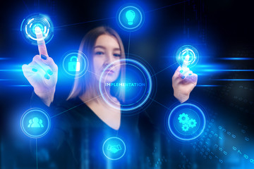 Business, Technology, Internet and network concept. Young businessman working on a virtual screen of the future and sees the inscription: Implementation