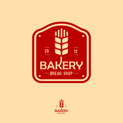 The bakery logo with spike. Bread and baking emblem. Vintage bakery logo. Inscription on a red sign.