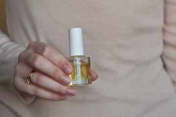 Woman giving herself elegant manicure applying polish on nails at home. Beauty treatment and hand care. Manicure at home. Quarantine.