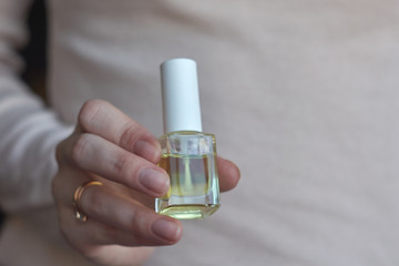 Woman giving herself elegant manicure applying polish on nails at home. Beauty treatment and hand care. Manicure at home. Quarantine.