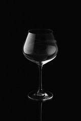 Clear empty wine glass isolated on black