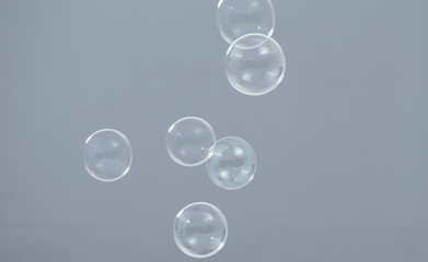 Shampoo bubbles floating like flying in the air by wind blow which represent refreshing playful or...