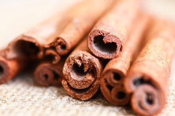 Cinnamon sticks on burlap backgroung Close up celected focus