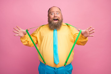 Portrait of his he nice funky carefree amazed bearded positive glad guy pulling suspenders having...