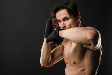 Fototapeta na wymiar Muscular shirtless man with boxing gloves