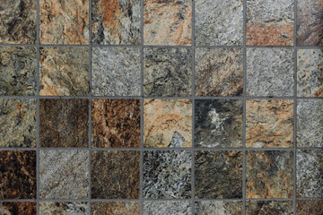 Fototapeta premium The colorful vintage ceramic tiles wall decoration,tile mosaic in the bathroom,vintage mosaic tiles texture background,gray and black mosaic wall texture and background