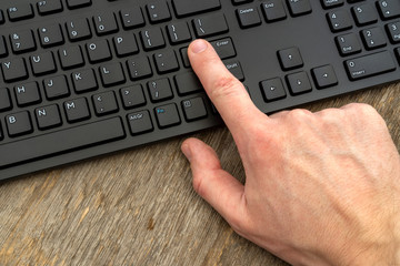 Hand typing on the computer keyboard