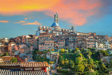 Siena - historical medieval town at sunset with view of the Dome & Bell Tower of Siena Cathedral (Duomo di Siena), landmark Mangia Tower and Basilica of San Domenico,Italy