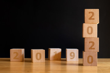 Wooden cubes with the word 2019 to 2020 on white background. Concept for success in the future goal. Happy new year