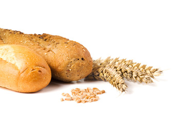 Baguettes, ripe ears of golden wheat and grain on white background. Close up, top view