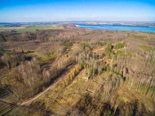 Fototapeta na wymiar Aerial view of reinforced concrete bunkers belonged to Headquarters of German Land Forces from ww2 hidden in a forest in spring season in Mamerki, Poland (former Mauerwald, East Prussia)