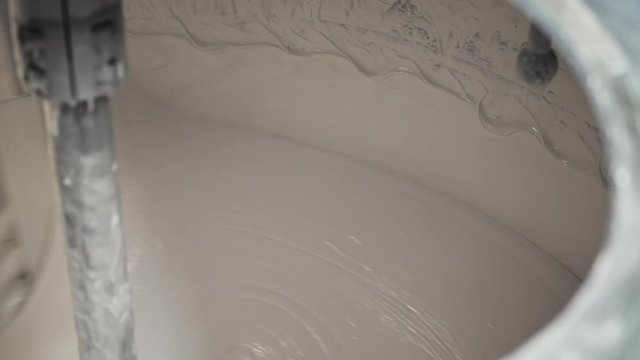 Toothpaste production process.  Close up of mixing toothpaste in a large  steel production container.