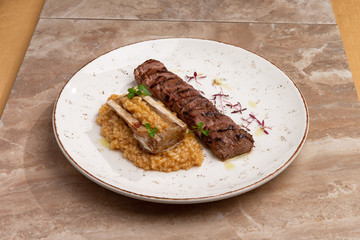 steak and brain bone on a risotto