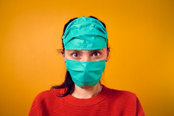 The girl in a mask on an orange