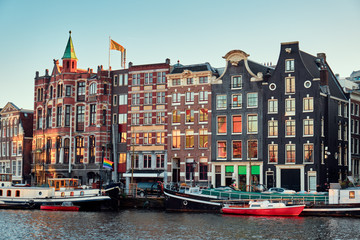 Naklejka premium Houses over a canal in the Amsterdam. City landscape.