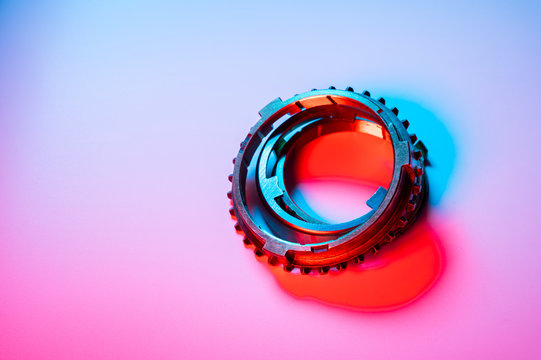 The individual elements of the transmission gear in the gearbox. A new set of synchronizers in brass in blue and red.