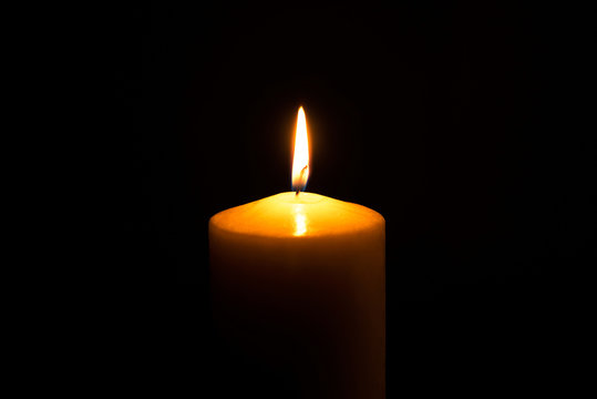Flame candle isolated on black background. Close up.